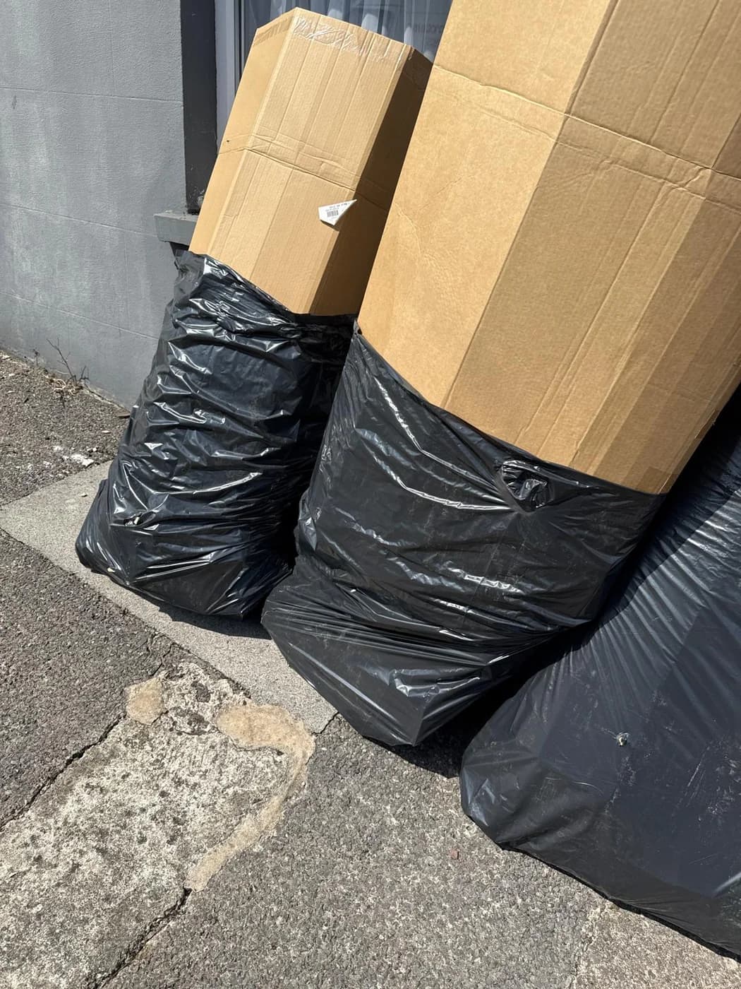 Bagged rubbish and boxes set out for collection in Swansea